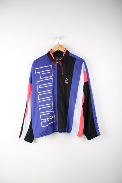 Vintage Puma equipe tracksuit top in black and purple. Features pink and white panel detail on the sleeves, embroidered logo on the chest and printed logo down the front.