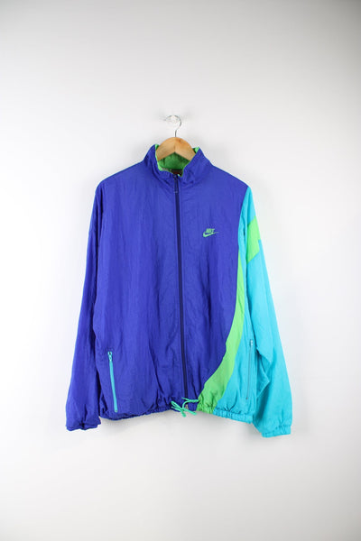 Vintage Nike shell jacket in purple, blue and green. Features embroidered logo on the chest.