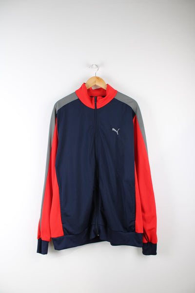 Puma tracksuit top in blue, grey and red. Features embroidered logo on the chest.
