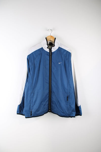 Vintage 90s Nike windbreaker jacket in blue and white. Features embroidered logo on the chest and back.