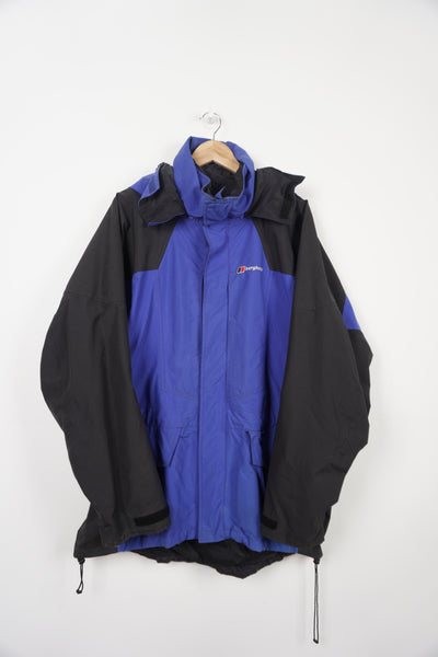 Blue and black Berghaus Gortex zip through waterproof jacket with embroidered logo, multiple pockets and foldaway hood 